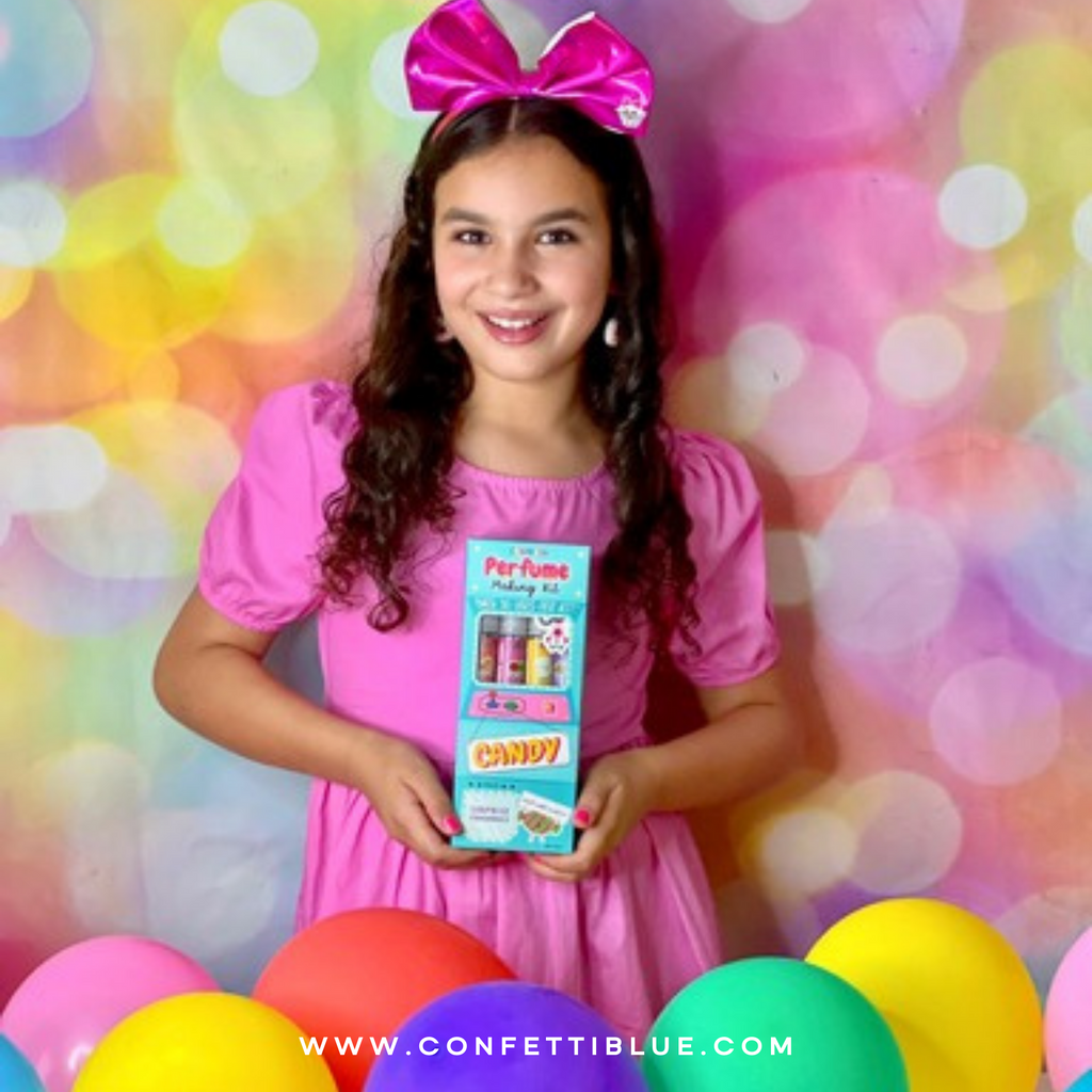 Confetti Blue Kids Perfume. Girl at birthday party with Confetti Blue Candy Scented Perfume Making Kit for Kids ready to play with perfume and kids makeup